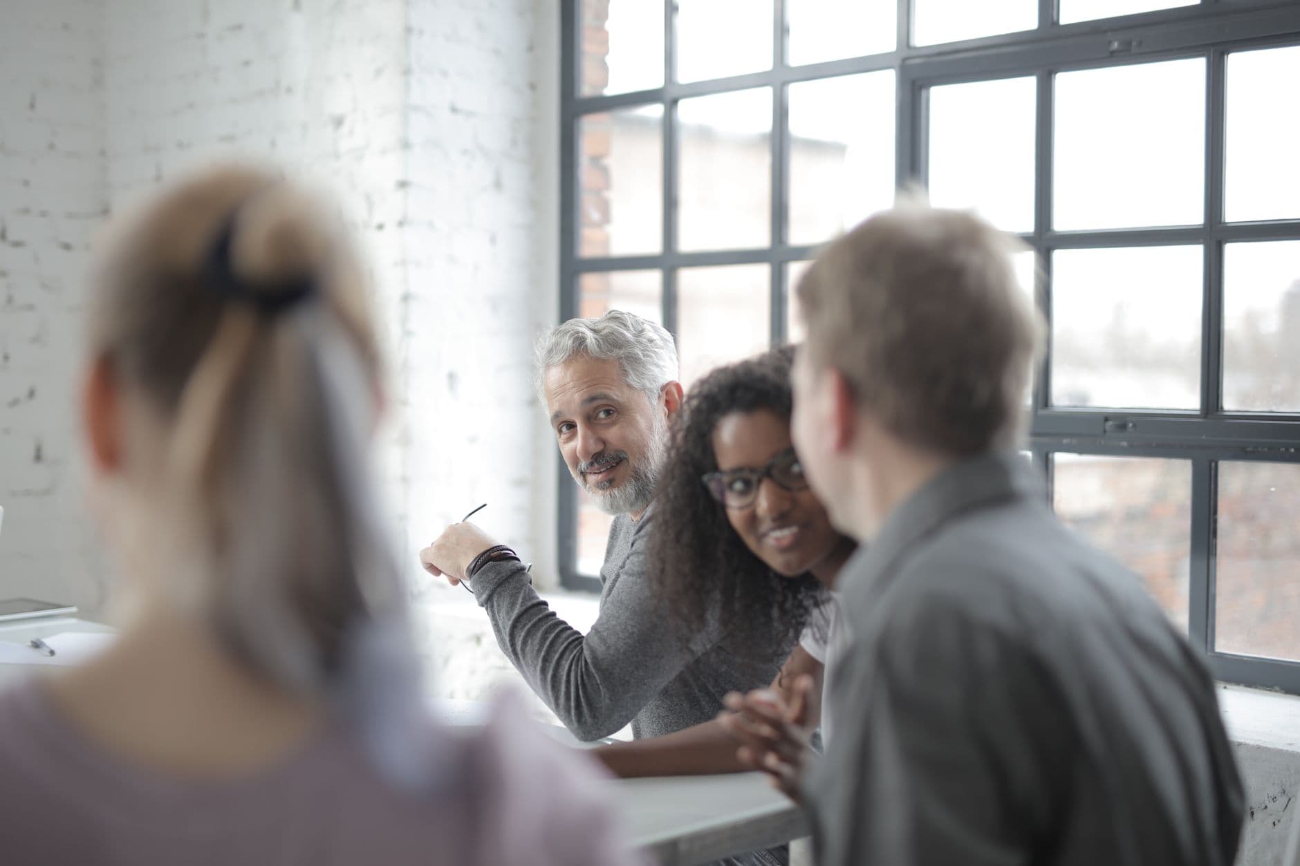Team gathered around an office table discussing a project