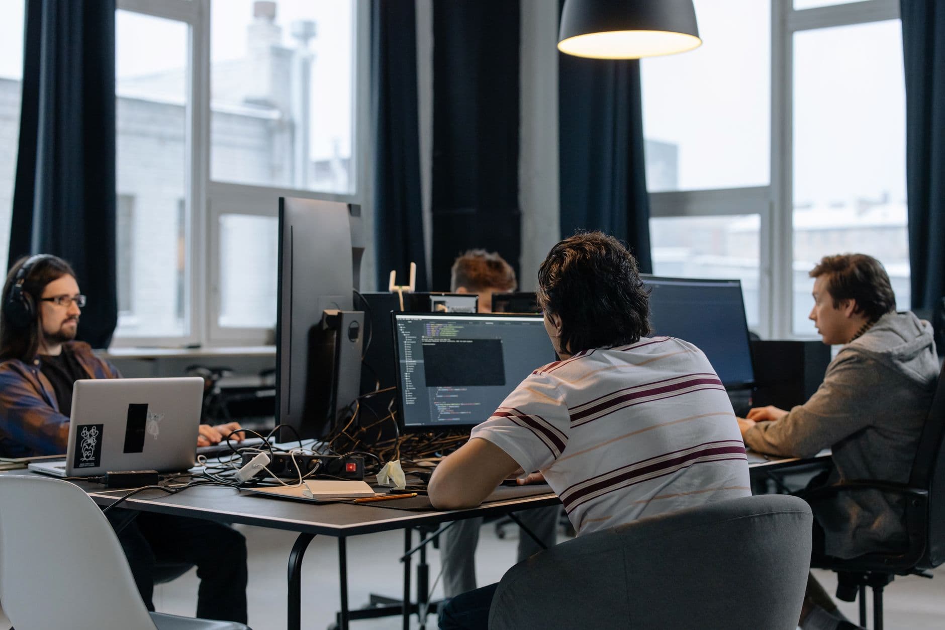 Technology team collaborating in front of computers at the office