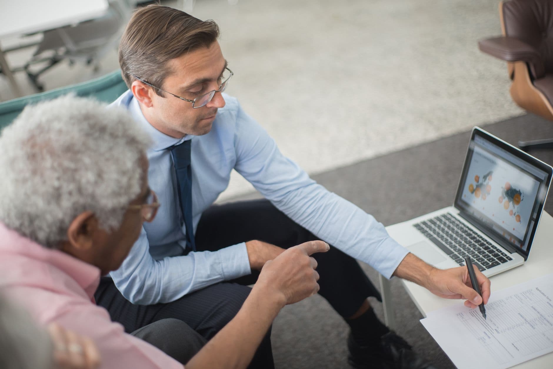 Business leader meeting an IT consultant over a laptop