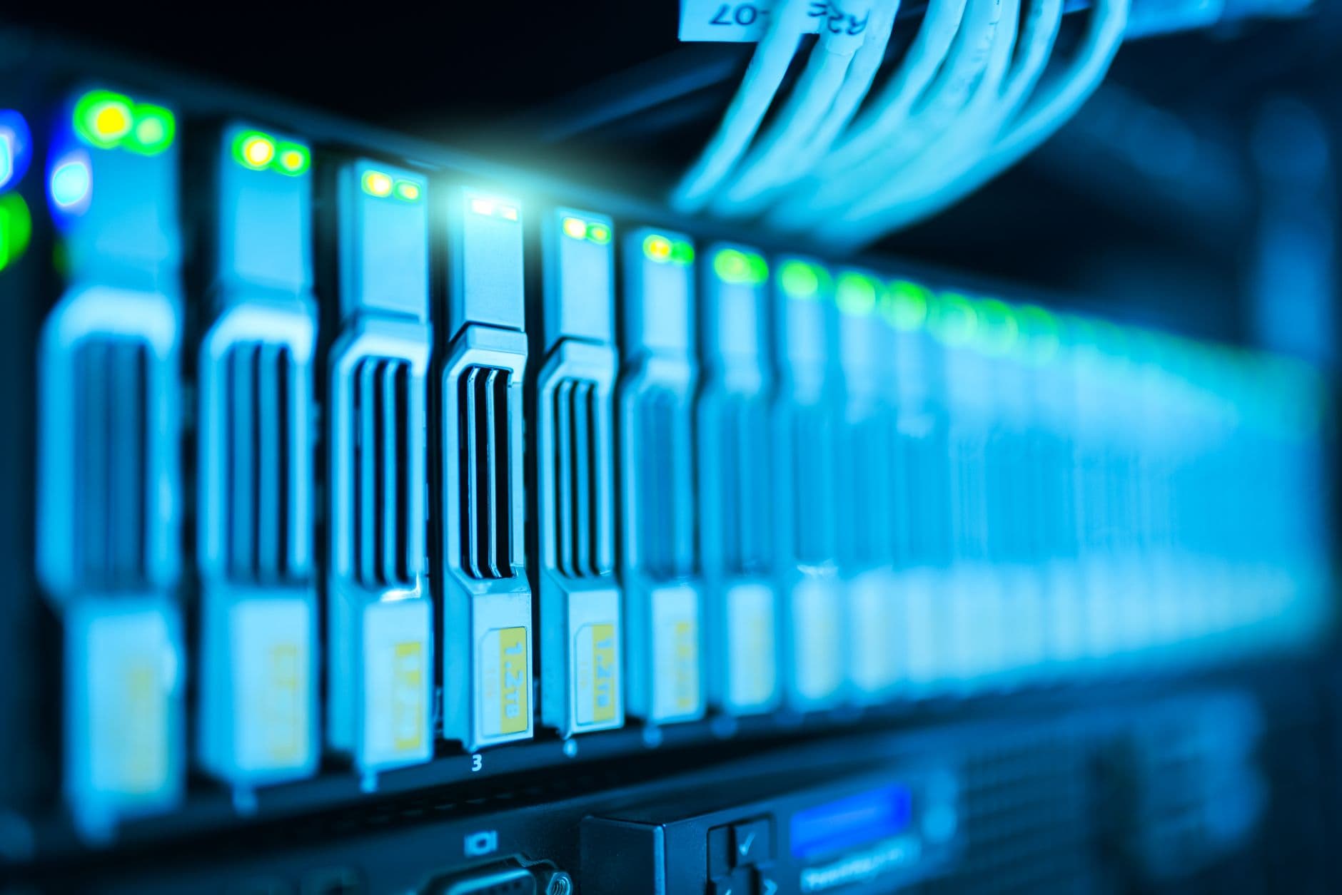 Rack servers with status lights and blue lighting in a data center
