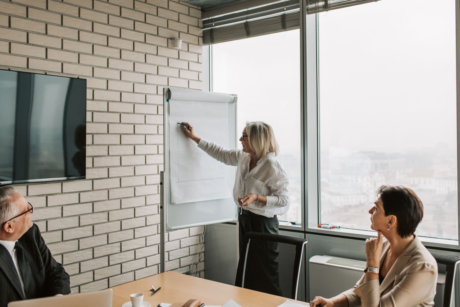 Consultant presenting a project timeline on a whiteboard