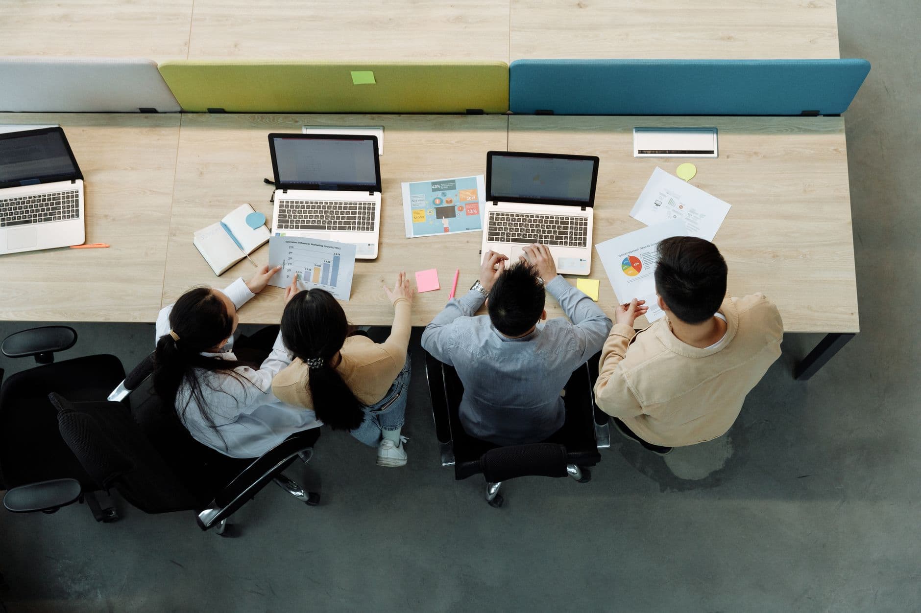 Coworkers collaborating on a cloud document through a laptop