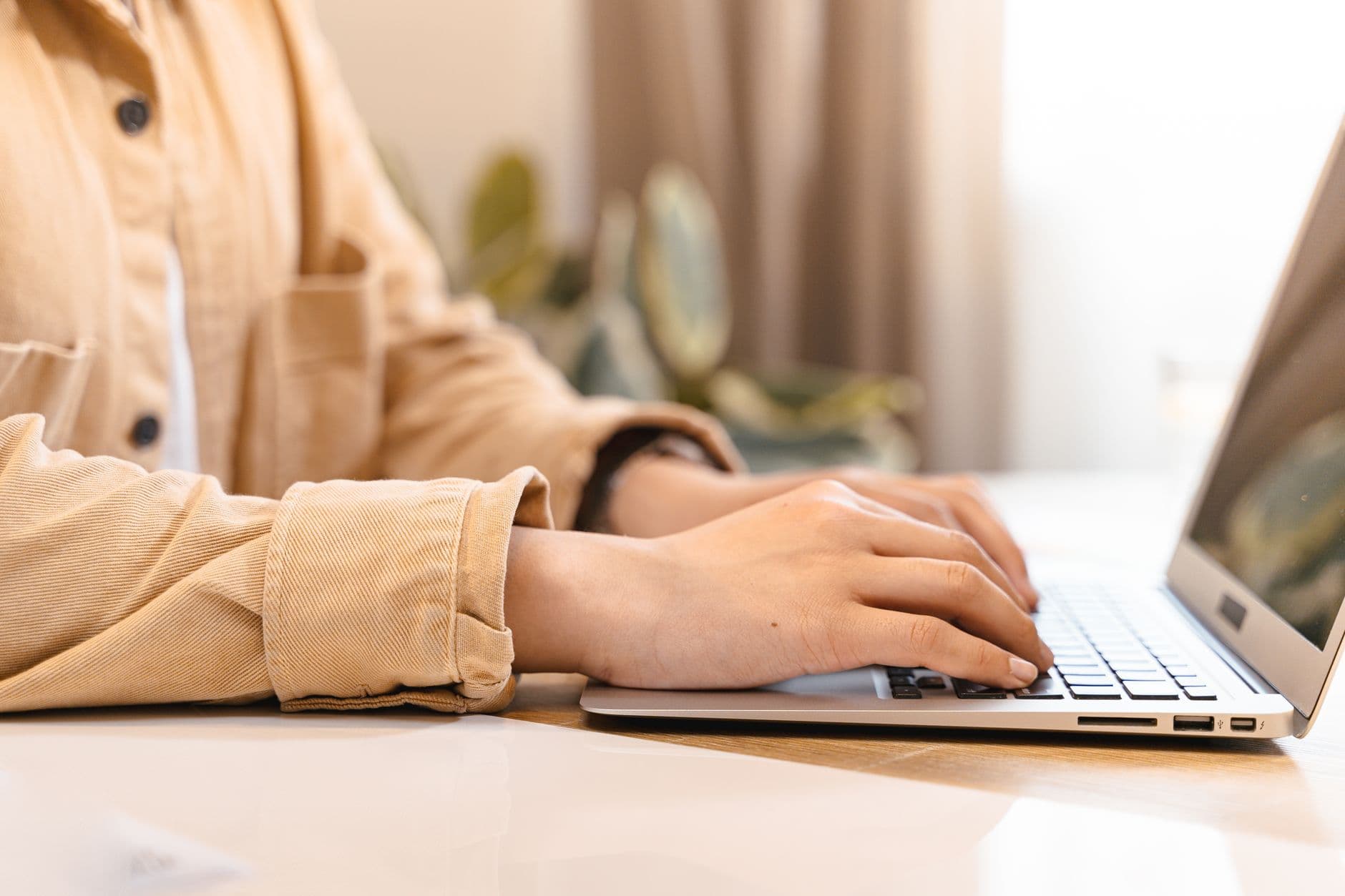 Person typing on a laptop in an office setting