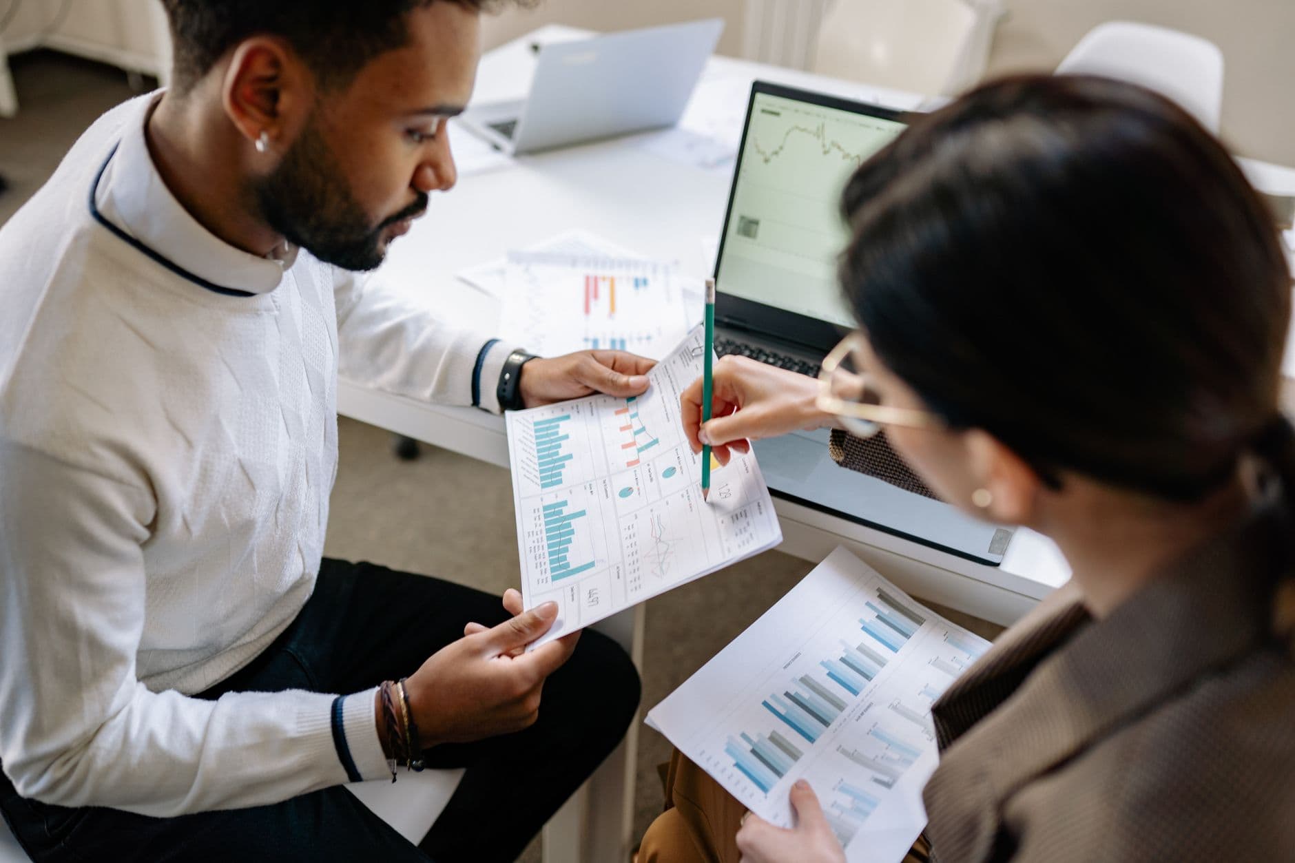 IT consultant discussing a security report with a colleague